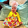 Blakely joined the competition — help win amazing prizes! baby, child, smiling, flower_headband, yellow_cardigan, colorful_dress, couch, pillows, indoor, happy, cute, portrait, sitting, headwear, clothing, infant, cheerful, home, bright_colors, fabric