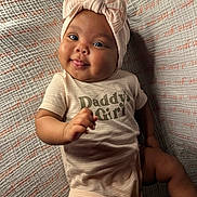 Dallis is registered to the contest to win money with this photo: baby, blanket, bow, child, cute, daddy's_girl, girl, hand, happy, headband, infant, laying_down, onesie, portrait, skin, smiling, soft_lighting, text_clothing, texture, tongue_out