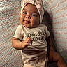 baby, blanket, bow, child, cute, daddy's_girl, girl, hand, happy, headband, infant, laying_down, onesie, portrait, skin, smiling, soft_lighting, text_clothing, texture, tongue_out