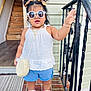 toddler, child, sunglasses, hair_buns, white_top, blue_shorts, white_sneakers, bracelets, necklace, purse, porch, brick_floor, doorway, railing, hand_raised, outdoor, fashion, cute, standing, smiling