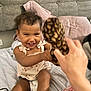 Davina is registered to the contest to win money with this photo: toddler, child, smiling, toy, plush, bed, pillow, hand, indoor, clothing, diaper, happy, person, hair, face, furniture, interaction, playing, cute, home