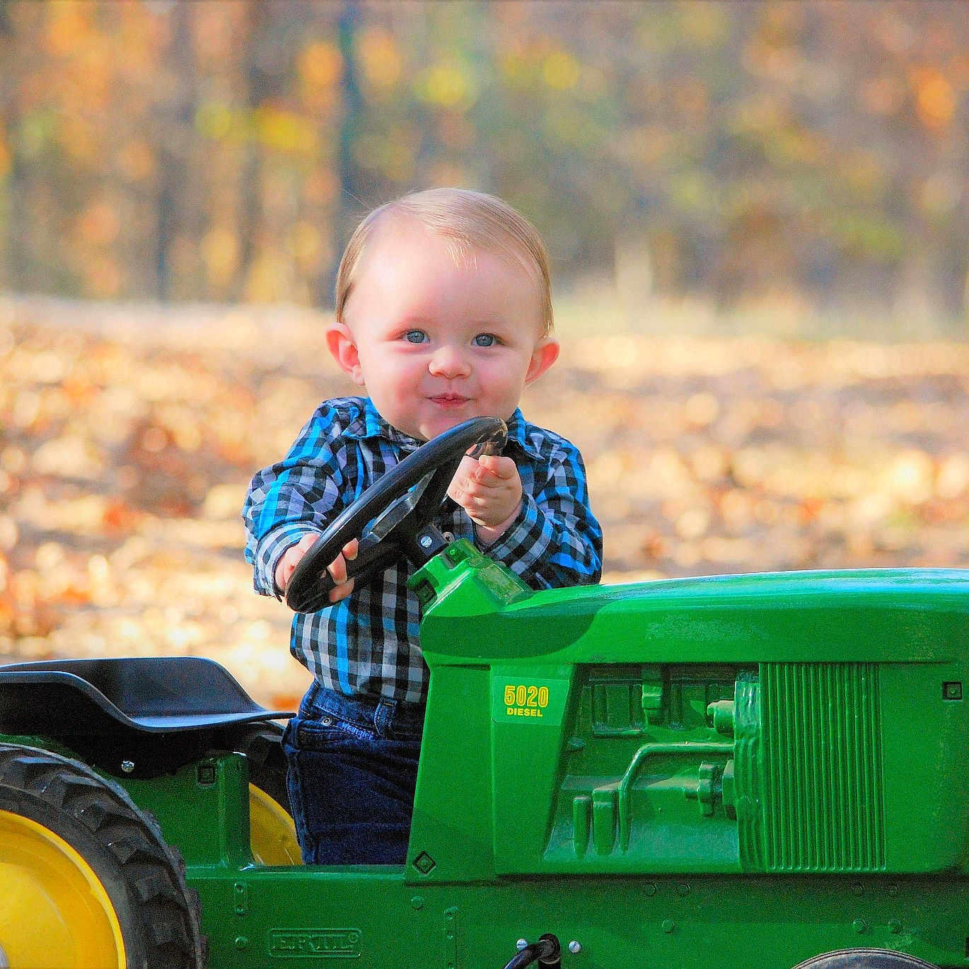 Lawrence joined the competition — help win amazing prizes! agricultural_machinery, child, farm, fun, grass, green, lawn, person, plant, play, toddler, tractor, tree, vehicle