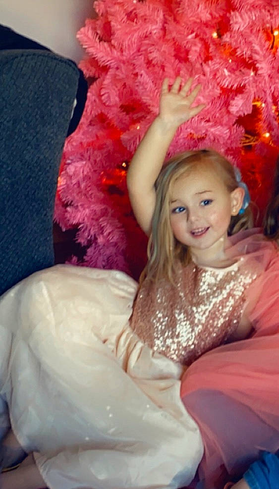 Sienna joined the competition — help win amazing prizes! blond, costume, dress, event, fashion_accessory, fashion_design, feather, flash_photography, fun, happy, headpiece, jewellery, joy, long_hair, magenta, peach, person, petal, pink, smile