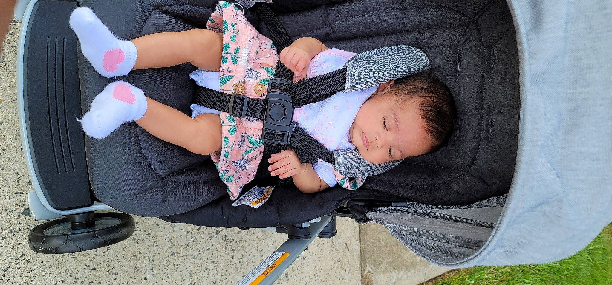 Naomi joined the competition — help win amazing prizes! baby, baby_carriage, baby_products, baby_toddler_clothing, child, comfort, finger, gesture, grass, hand, hat, human_leg, lap, leg, person, product, sitting, sock, thigh, toddler