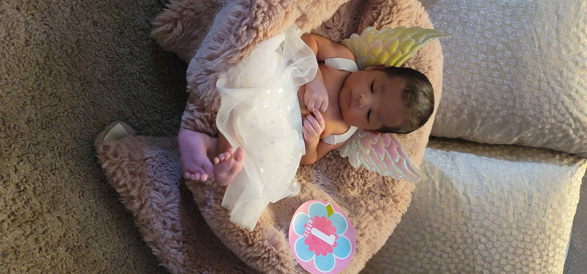 Naomi is registered to the contest to win money with this photo: baby, baby_products, baby_toddler_clothing, bedtime, child, comfort, flooring, fun, grass, linens, nap, pattern, person, play, room, sitting, skin, sleeve, soil, toddler