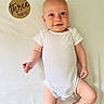 Eli joined the competition — help win amazing prizes! baby, infant, onesie, blanket, wooden_plaque, three_months, blue_eyes, smile, cute, lying_down, skin, child, newborn, portrait, happy, soft_texture, indoors, white_background, small_hands, barefoot
