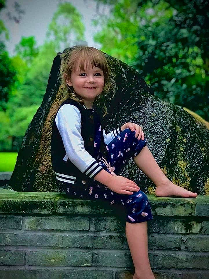 Lilly-anne is registered to the contest to win money with this photo: black_hair, cool, electric_blue, facial_expression, flash_photography, fun, grass, green, happy, joy, leisure, long_hair, people_in_nature, person, smile, stairs, standing, sunlight, thigh, tree