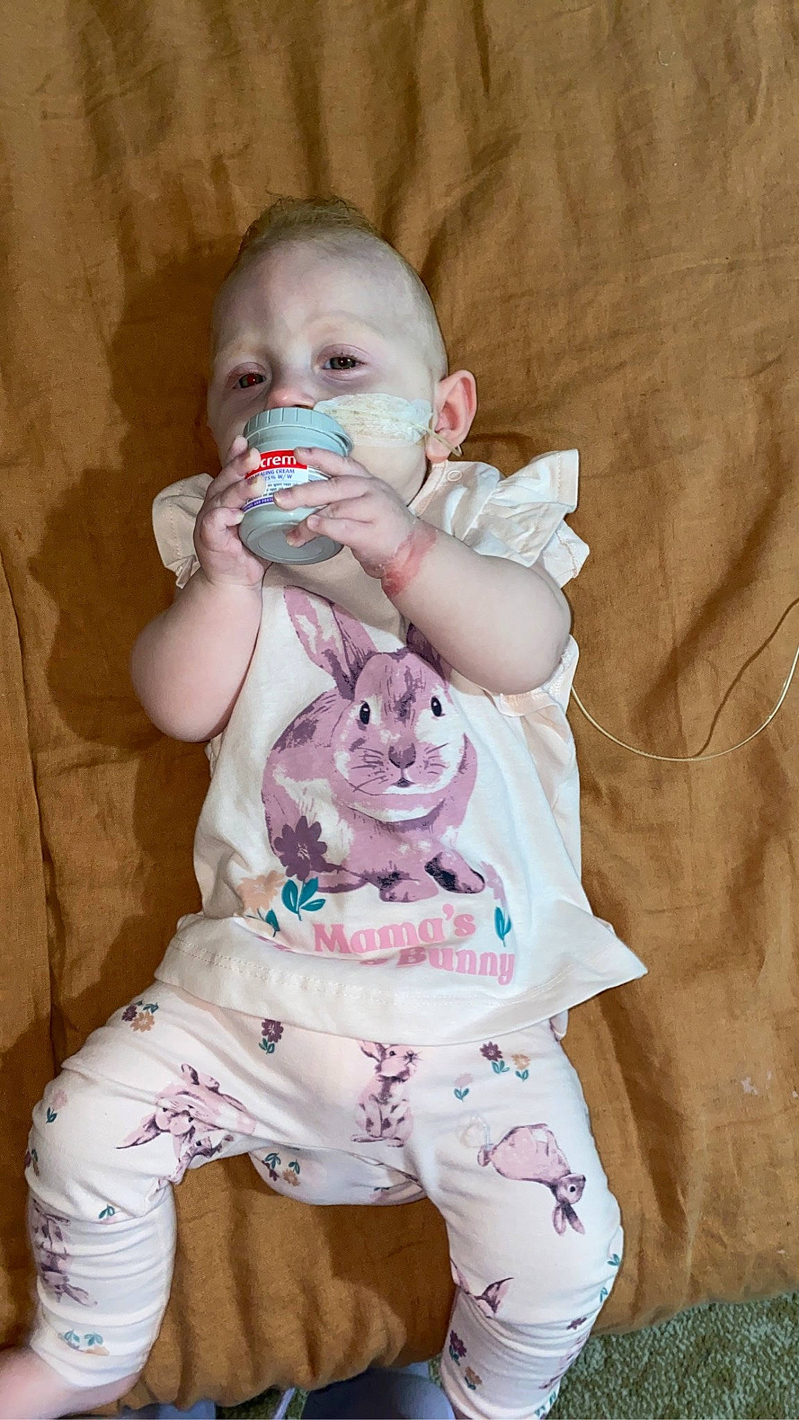 Marley is registered to the contest to win money with this photo: arm, baby, baby_products, baby_toddler_clothing, cheek, child, comfort, finger, fun, hand, happy, head, mouth, person, pink, sitting, skin, sleeve, t_shirt, textile