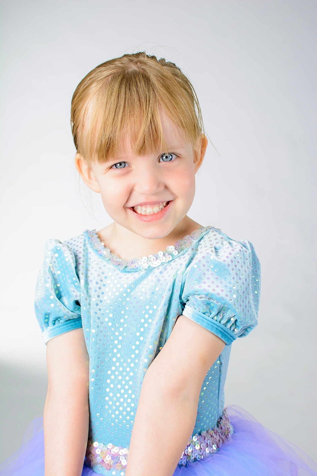 Cloetta is registered to the contest to win money with this photo: child, girl, smile, blue_dress, tutu, sparkles, blonde_hair, portrait, happy, studio, dance, costume, puffy_sleeves, young, face, cute, fashion, childhood, innocence, posing