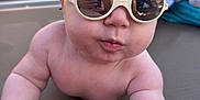 Jules participe au concours pour gagner de l'argent avec cette photo : baby, child, sunglasses, reflection, pool, outdoor, lounge_chair, cute, summer, skin, person, sunshine, bare_chest, hand, infant, fun, relaxation, daytime, fashion, accessory