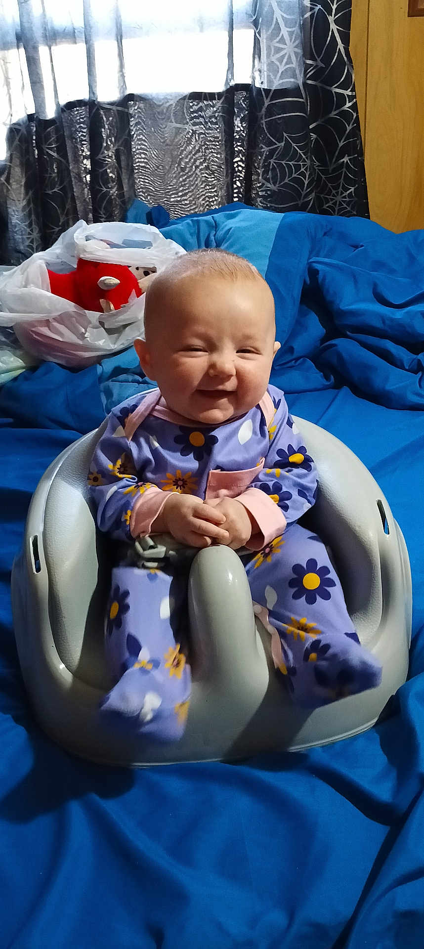 Margaret Hamilton joined the competition — help win amazing prizes! baby, baby_seat, bedding, blue_bedspread, curtains, cute, face, feet, floral_pattern, hands, happy, indoors, infant, onesie, plastic_bag, plush_toy, portrait, smile, window, wood_wall