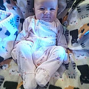 Margaret Hamilton joined the competition — help win amazing prizes! baby, blanket, cat_pattern, child, clothing, comfort, cozy, cute, face, happy, indoor, infant, onesie, pattern, portrait, sitting, smile, soft, warm, young