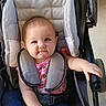 baby, baby_girl, blue_pants, carriage, casual, child, childcare, clothing, cute, happy, indoor, infant, leisure, person, pink_socks, portrait, seat, seatbelt, smiling, stroller