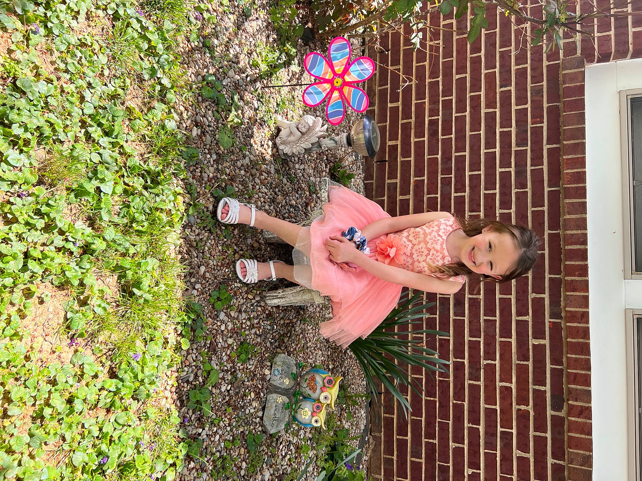 Adalynn Joy is registered to the contest to win money with this photo: brick, building, flower, fun, garden, grass, groundcover, happy, house, joy, leisure, pattern, people_in_nature, person, plant, shrub, toy, tree, visual_arts, window