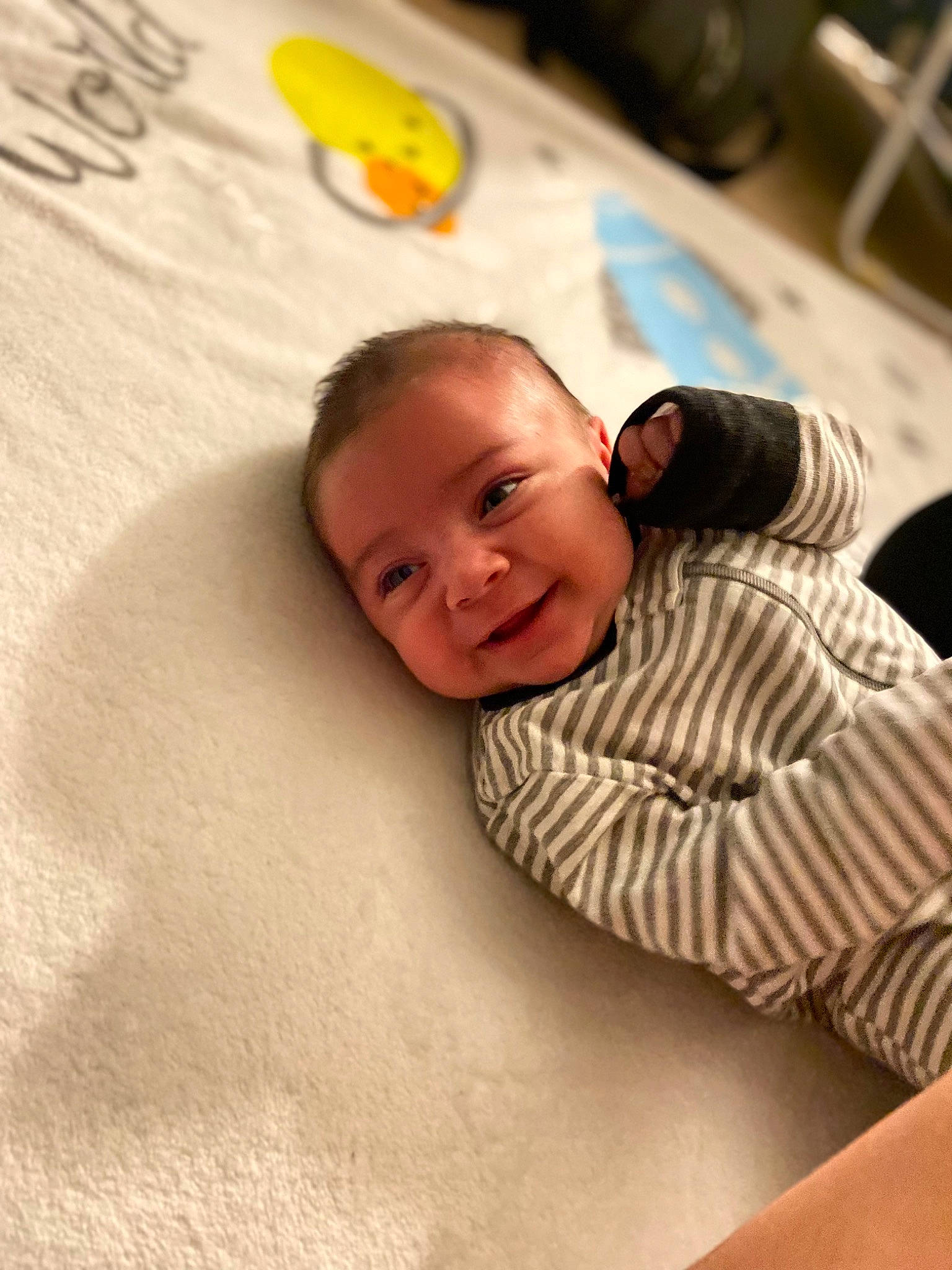 Luis is registered to the contest to win money with this photo: baby, cheek, comfort, eyebrow, finger, floor, flooring, fun, hairstyle, happy, hardwood, joy, linens, mouth, nose, person, room, skin, smile, t_shirt