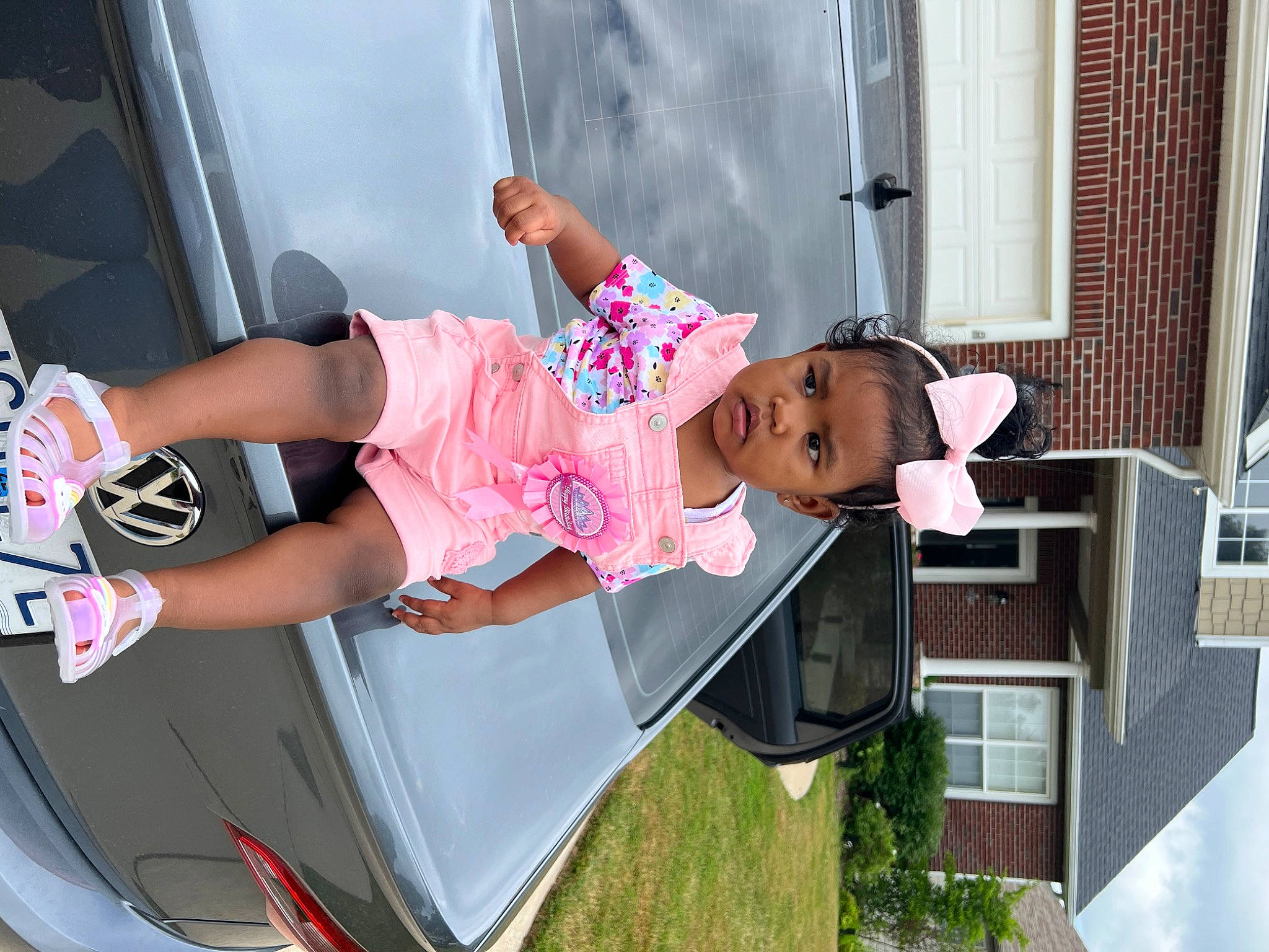 Chloe is registered to the contest to win money with this photo: automotive_design, automotive_exterior, automotive_lighting, bumper, car, fashion, fun, hood, leg, motor_vehicle, person, pink, sandal, shorts, sneakers, thigh, trunk, vehicle, vehicle_door, wheel