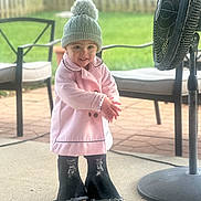 Hadli is registered to the contest to win money with this photo: cap, chair, child, clothing, coat, face, female, footwear, furniture, girl, grass, hat, head, machine, person, photography, plant, portrait, shoe, wheel