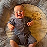 Malakai joined the competition — help win amazing prizes! baby, infant, smiling, happy, plush, cushion, soft, cozy, child, person, clothing, wooden_plaque, milestone, portrait, indoors, cute, sitting, hands, face, head