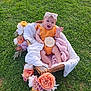 baby, infant, basket, flowers, grass, blanket, headband, orange_outfit, smiling, waving, outdoor, nature, greenery, cute, celebration, 5_months, portrait, child, happy, soft_texture