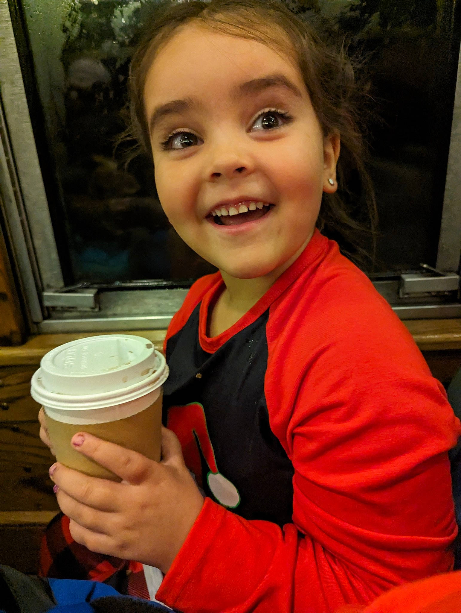 Emma is registered to the contest to win money with this photo: cheek, child, coffee_cup_sleeve, drink, food, food_craving, hand, happy, joy, laugh, person, picture_frame, plant, portrait_photography, smile, t_shirt, thumb, toddler