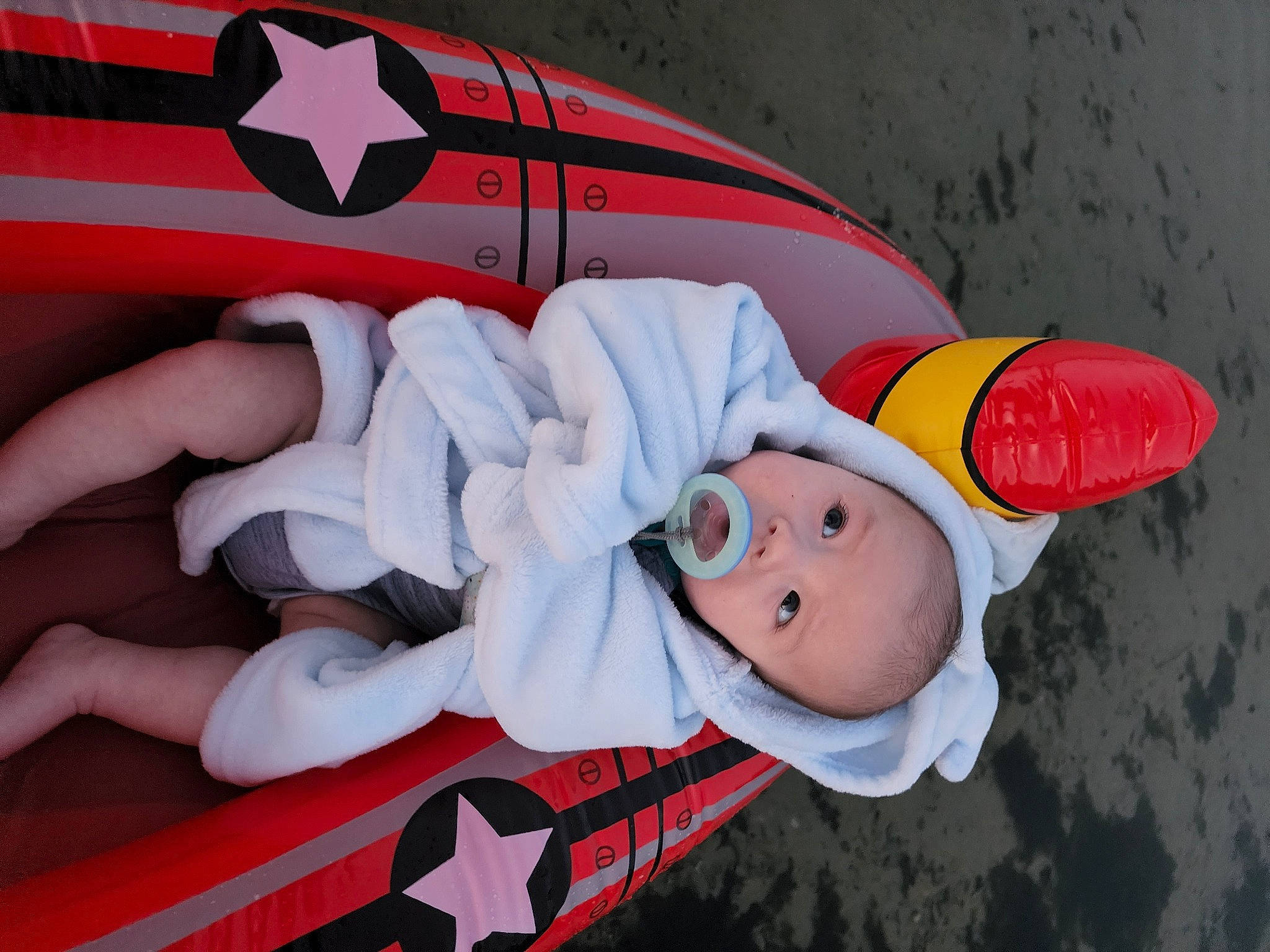 Colton is registered to the contest to win money with this photo: boats_and_boating_equipment_and_supplies, cap, carmine, costume_hat, fashion_accessory, fun, hat, human_leg, lap, leisure, orange, person, personal_protective_equipment, recreation, stuffed_toy, sun_hat, toy, travel, vehicle_door, water_transportation
