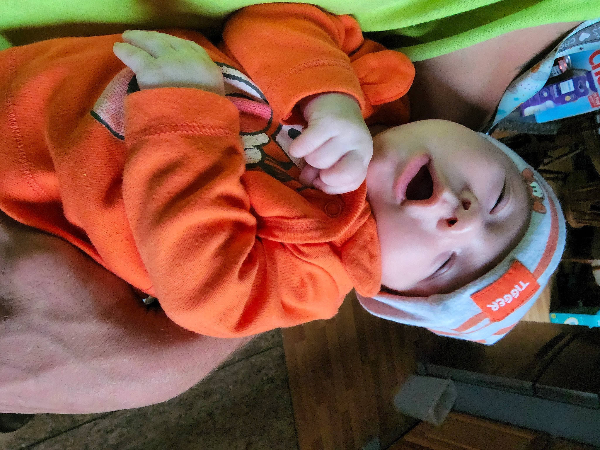 Colton is registered to the contest to win money with this photo: baby, baby_products, baby_sleeping, baby_toddler_clothing, child, comfort, fun, hat, headgear, headwear, hoodie, linens, mouth, orange, peach, person, personal_protective_equipment, polar_fleece, sitting, sleeve
