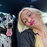 Huckleberry Hound is registered to the contest to win money with this photo: black_clothing, blonde_hair, blue_sky, bright_lipstick, car, casual, dog, great_dane, happy, inside_car, leisure, pet, playful, portrait, seat, selfie, smiling, sunroof, tongue_out, woman
