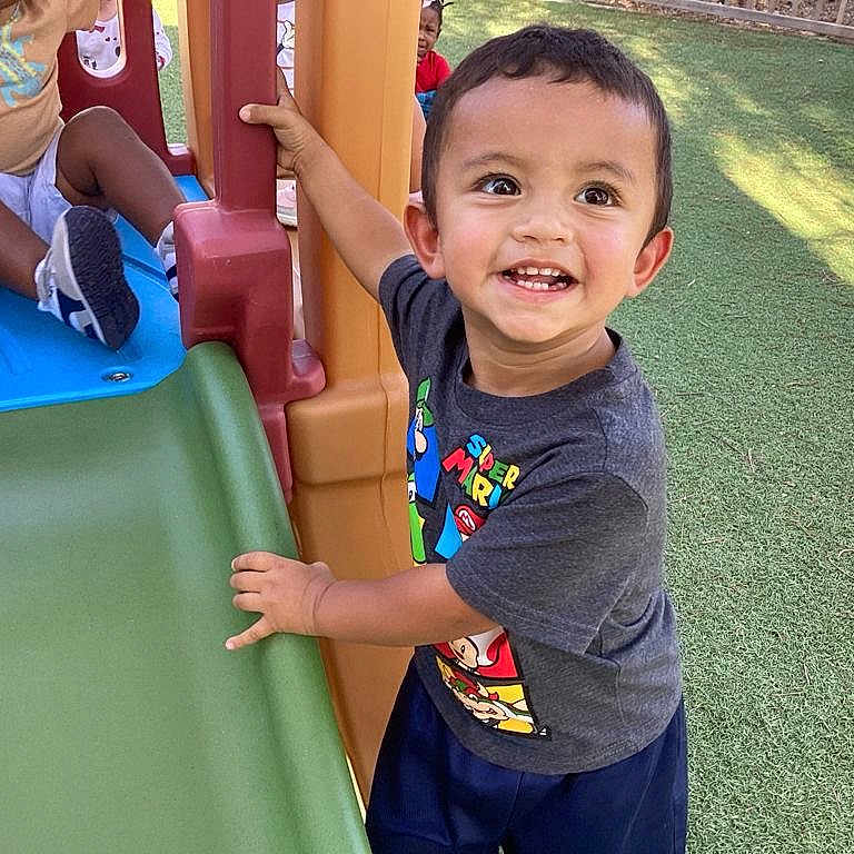 Damian Politz joined the competition — help win amazing prizes! activity, casual_clothing, child, daylight, friends, fun, grass, happy, outdoor, park, person, play, playground, recreation, slide, smiling, super_mario, toddler, tshirt, young_child