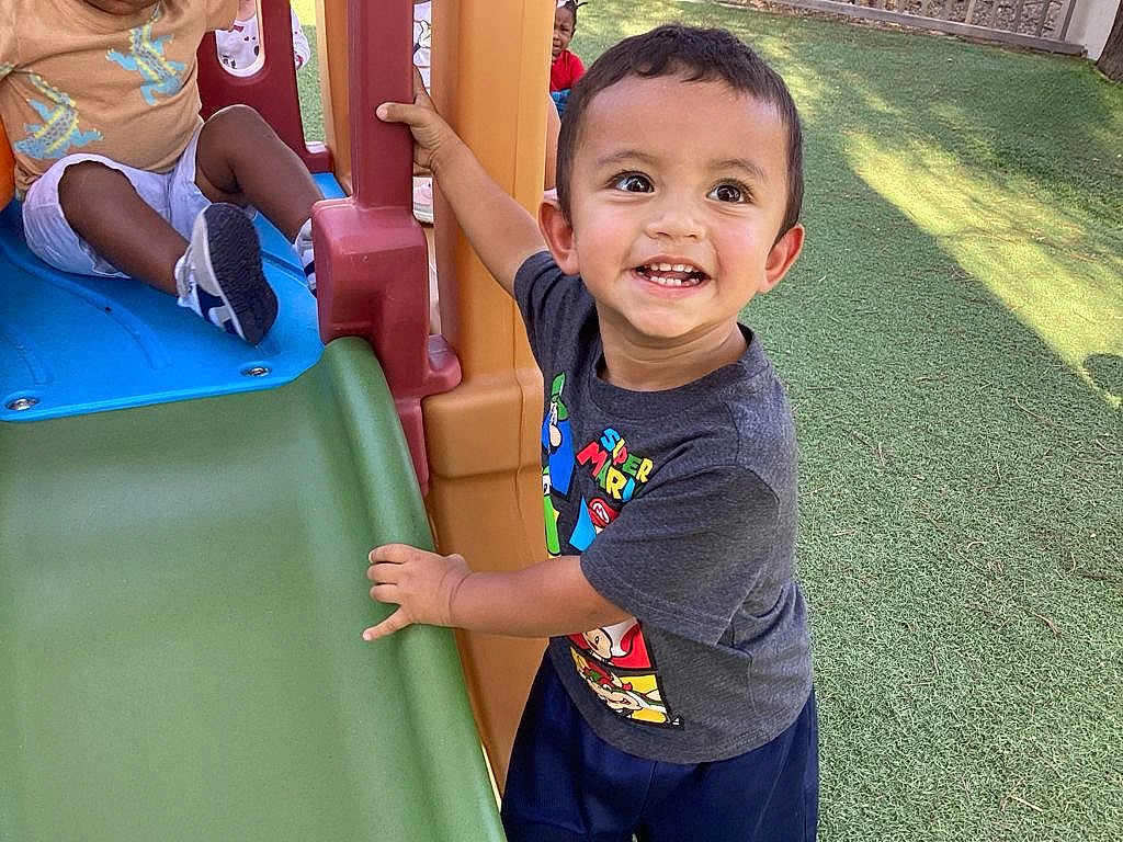 Damian Politz joined the competition — help win amazing prizes! child, toddler, playground, slide, outdoor, smiling, super_mario, tshirt, grass, happy, play, fun, person, daylight, park, young_child, casual_clothing, activity, friends, recreation