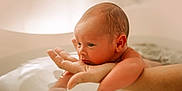 Louis participe au concours pour gagner de l'argent avec cette photo : newborn, baby, infant, hand, water, bath, skin, face, arm, adult, closeup, portrait, soft_light, indoors, child, peaceful, resting, human, parent, care