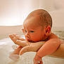newborn, baby, infant, hand, water, bath, skin, face, arm, adult, closeup, portrait, soft_light, indoors, child, peaceful, resting, human, parent, care
