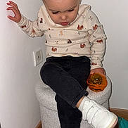 Raven participe au concours pour gagner de l'argent avec cette photo : black_pants, casual, child, childrens_clothing, cozy_corner, cross_legged, cute, hair_buns, indoor, long_eyelashes, looking_down, orange_toy, ottoman, patterned_sweater, sitting, toddler, toy, wall_outlet, white_sneakers, wooden_floor