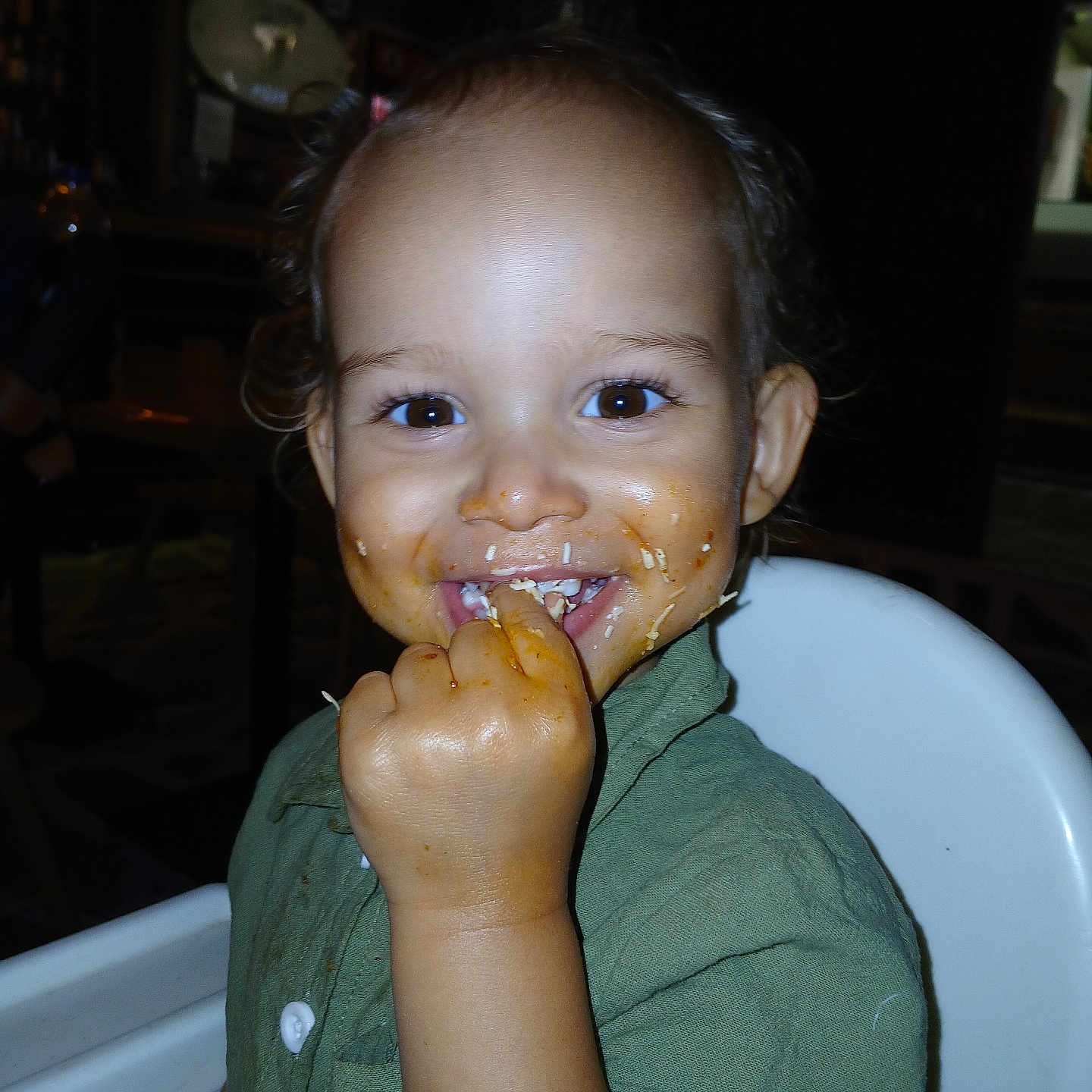 Cillian-Franklyn is registered to the contest to win money with this photo: baby, child, cute, dining, eating, eyes, face, food, green_shirt, hand, happy, high_chair, indoor, meal, messy_face, person, seat, smiling, toddler, young_child