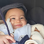 Isaac participe au concours pour gagner de l'argent avec cette photo : baby, child, smiling, face, hand, fleece, jacket, hat, string, cozy, cute, infant, portrait, warm, innocent, happy, clothing, closeup, babywear, person