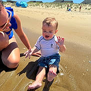 Wesley is registered to the contest to win money with this photo: toddler, child, adult, beach, sand, water, sunny, blue_sky, summer, playing, splashing, happy, casual_clothing, vacation, outdoor, family, fun, sand_dune, people, sunlight