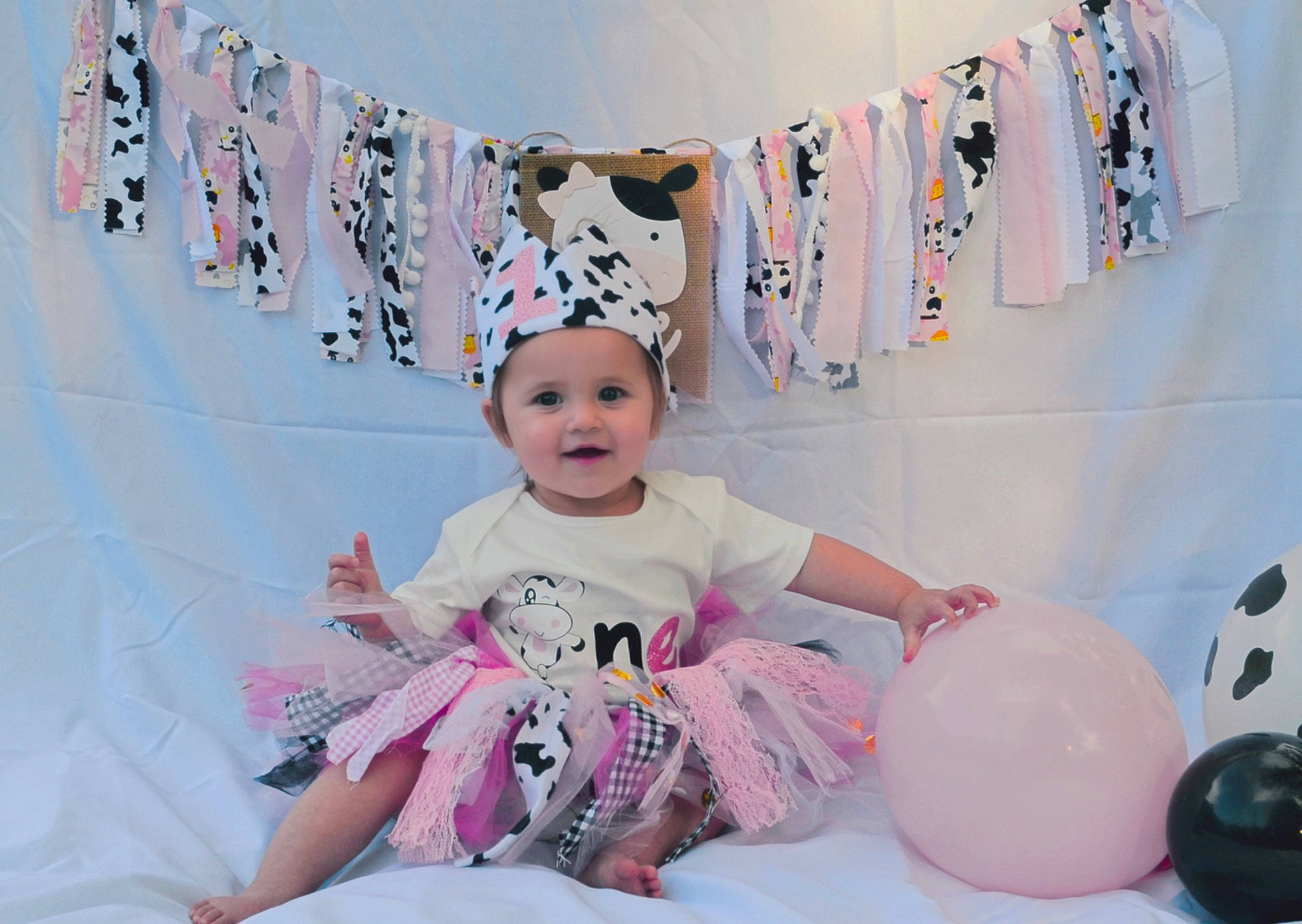 Nicole is registered to the contest to win money with this photo: art, baby, baby_toddler_clothing, balloon, child, event, fun, happy, headwear, joy, leisure, magenta, party, party_supply, person, pink, purple, room, sitting, smile