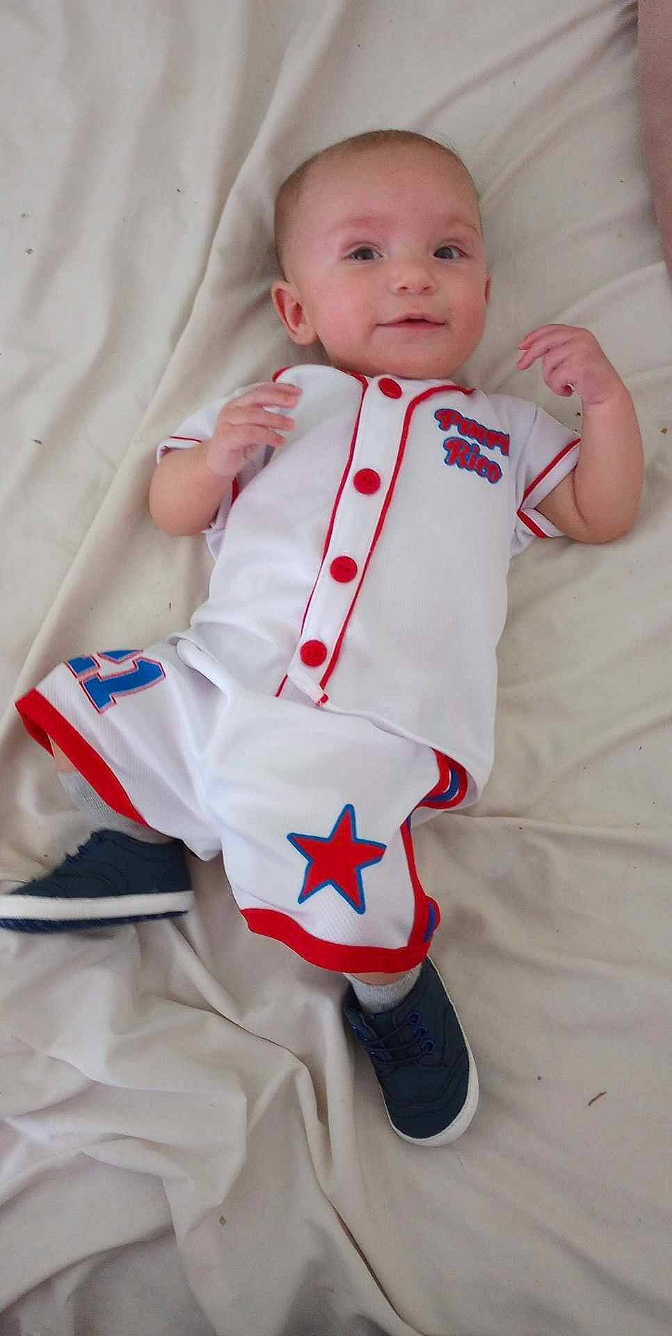 Malakai is registered to the contest to win money with this photo: baby, baby_products, baby_safety, baby_toddler_clothing, carmine, child, collar, comfort, dress, event, gesture, happy, linens, pattern, person, service, sleeve, smile, thumb, toddler