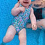baby, blue, child, cute, floating, fun, hand, happy, infant, outdoor, person, play, pool, skin, smiling, splash, summer, support, swimsuit, water
