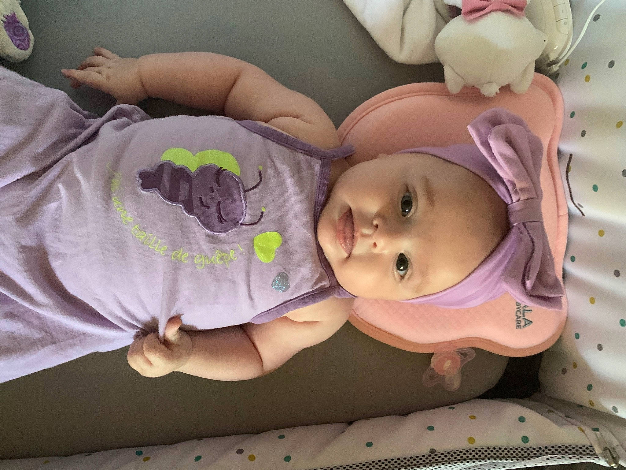 Gyulia participe au concours pour gagner de l'argent avec cette photo : baby, baby_products, baby_sleeping, baby_toddler_clothing, cheek, child, comfort, eye, eyelash, head, headgear, headwear, human_body, iris, linens, mouth, person, pink, purple, room