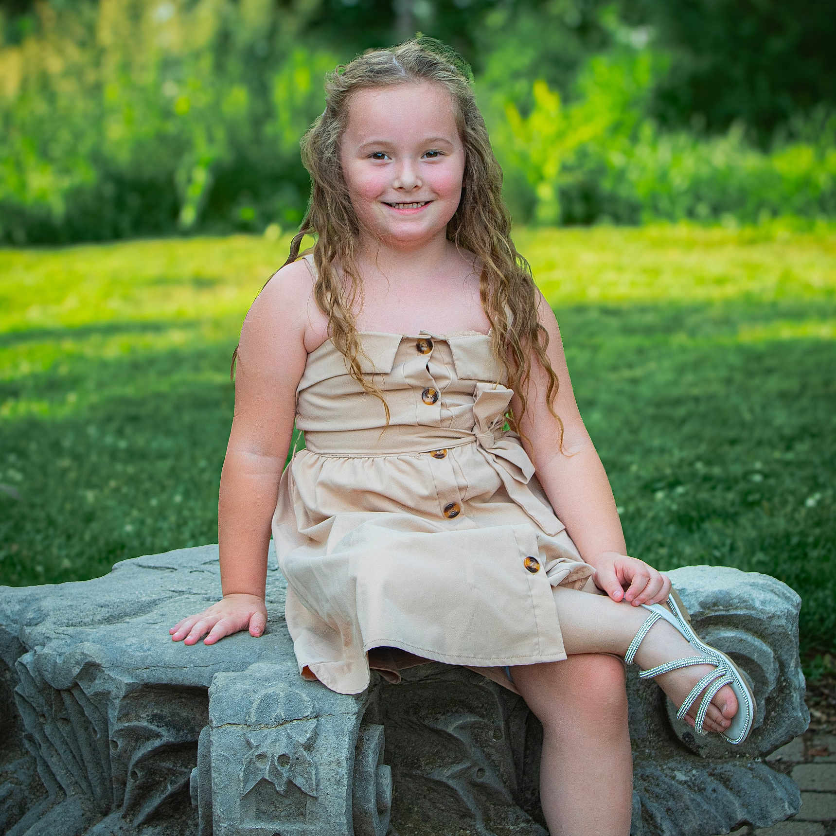 Octavia is registered to the contest to win money with this photo: blonde, child, clothing, dress, eveningdress, face, female, footwear, girl, grass, hair, happy, head, person, photography, plant, portrait, sandal, sitting, smile
