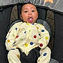 baby, infant, onesie, smiley_face, seat, baby_seat, straps, tongue_out, expression, indoor, toy, star_toy, ball_toy, fabric, mesh, comfort, cute, child, person, clothing