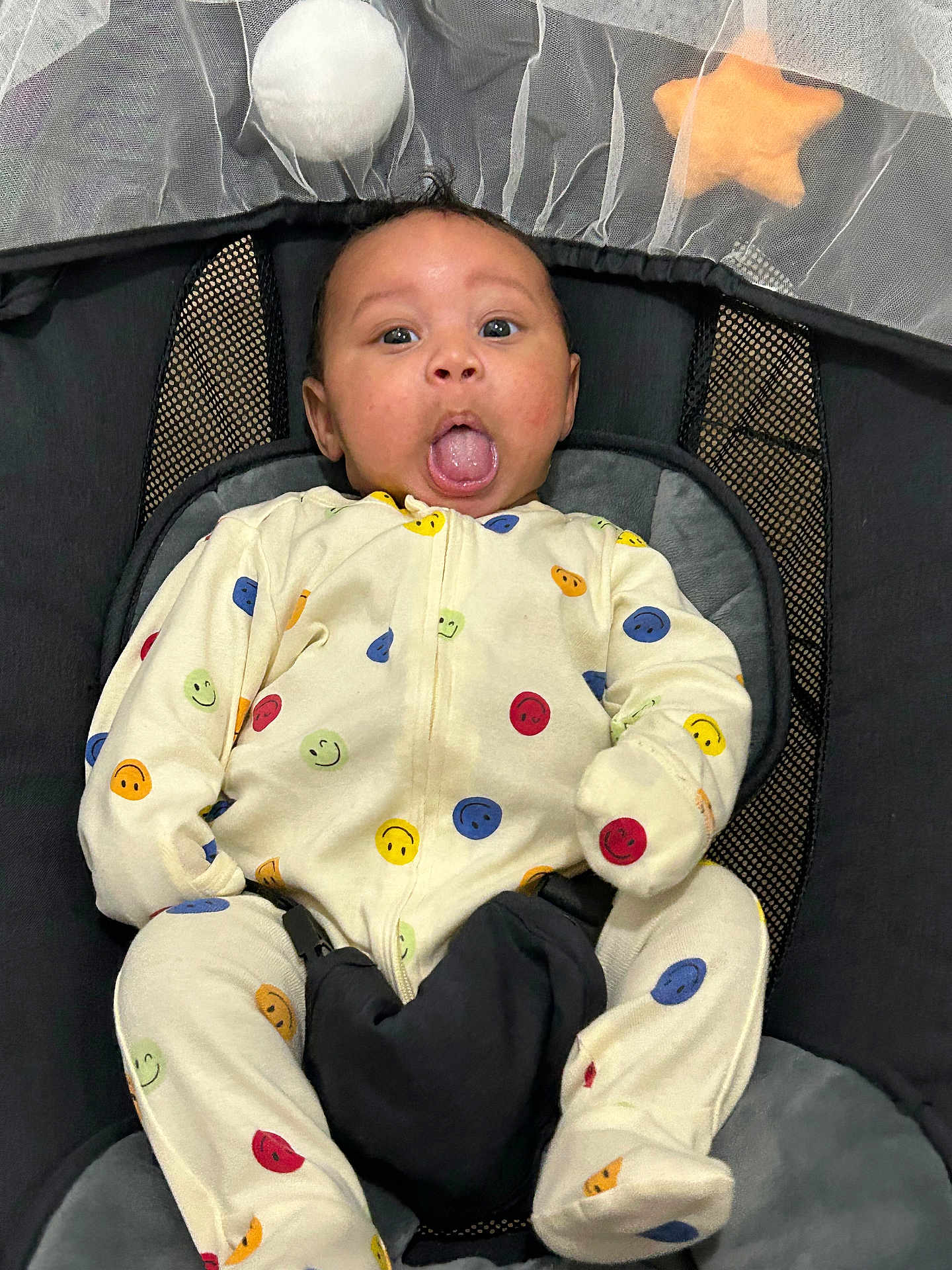 Alex joined the competition — help win amazing prizes! baby, infant, onesie, smiley_face, seat, baby_seat, straps, tongue_out, expression, indoor, toy, star_toy, ball_toy, fabric, mesh, comfort, cute, child, person, clothing