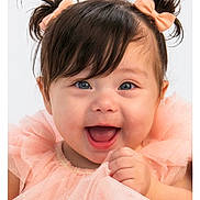 Winter is registered to the contest to win money with this photo: baby, child, girl, smiling, happy, pigtails, bows, blue_eyes, dress, peach_color, tulle, cute, portrait, close_up, infant, hand, joyful, studio, white_background, fashion