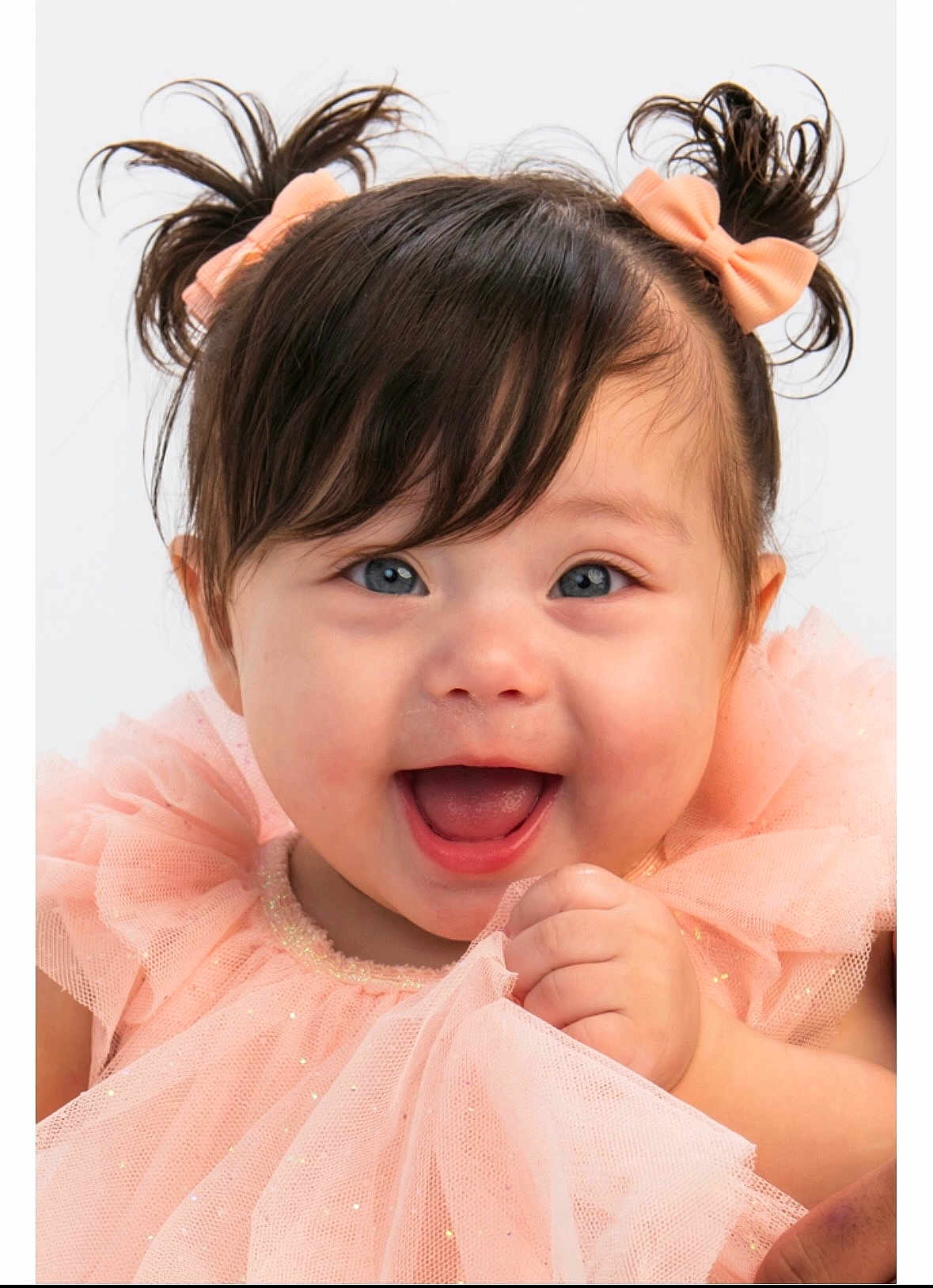 Winter is registered to the contest to win money with this photo: baby, child, girl, smiling, happy, pigtails, bows, blue_eyes, dress, peach_color, tulle, cute, portrait, close_up, infant, hand, joyful, studio, white_background, fashion