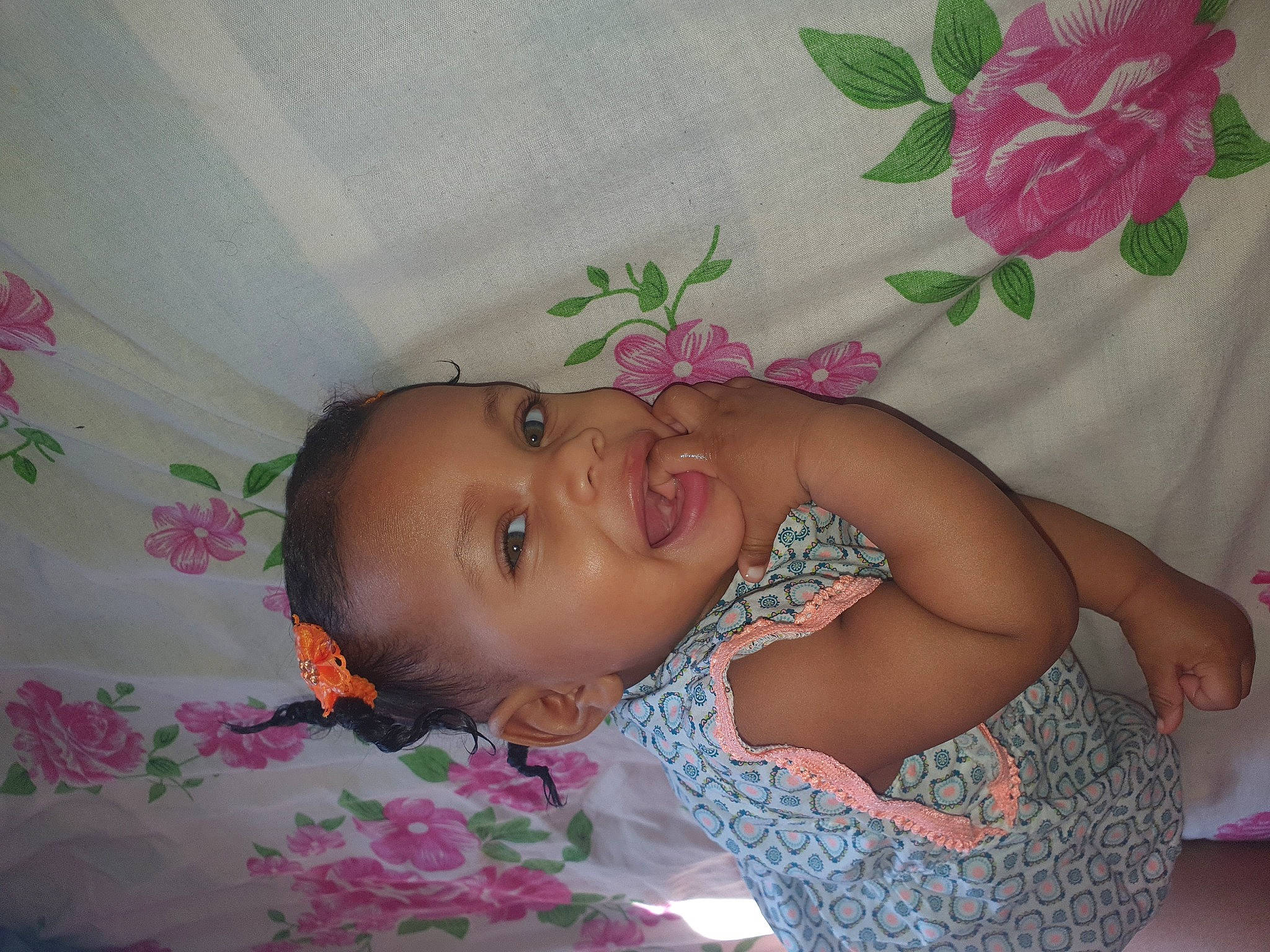 Lyah participe au concours pour gagner de l'argent avec cette photo : arm, baby, baby_products, baby_toddler_clothing, cheek, child, eye, finger, happy, linens, magenta, mouth, pattern, person, petal, pink, room, skin, smile, textile