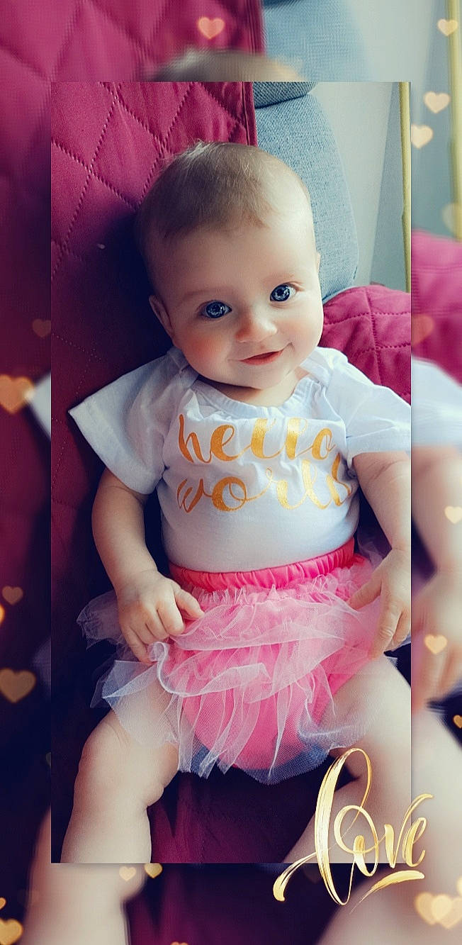 Sharon participe au concours pour gagner de l'argent avec cette photo : baby, baby_products, baby_toddler_clothing, cheek, child, dress, eye, iris, person, pink, product, skin, smile, toddler