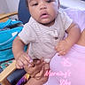 Ami joined the competition — help win amazing prizes! baby, infant, child, portrait, sitting, being_held, adult, face, eyes, curious, indoors, window, chair, suitcase, striped_clothing, pink_clothing, colorful_fabric, morning, text_overlay, family