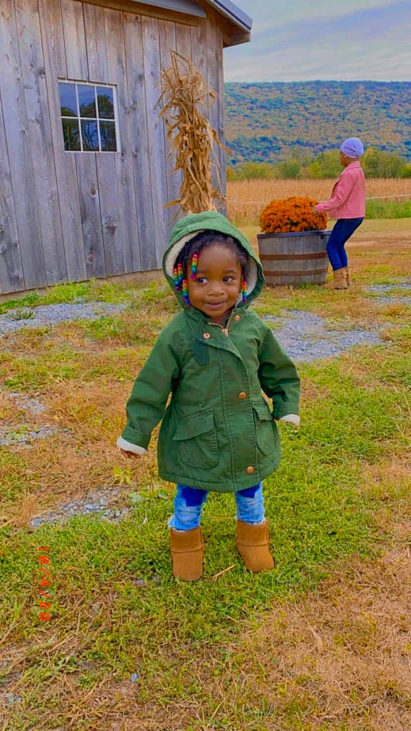 Maloni is registered to the contest to win money with this photo: baby_toddler_clothing, door, fun, grass, grass_family, grassland, happy, hat, jacket, joy, landscape, lawn, leisure, people_in_nature, person, plant, recreation, sky, smile, soil