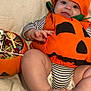 Zaïen participe au concours pour gagner de l'argent avec cette photo : baby, blanket, candy, child, costume, cute, feet, festive, halloween, hand, holiday, infant, orange, portrait, pumpkin_costume, skeleton_hand, smiling, soft_texture, striped_clothing, toy