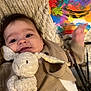Zaïen participe au concours pour gagner de l'argent avec cette photo : abstract_art, baby, blanket, child, clothing, colorful, comfort, cozy, cute, face, hand, indoor, infant, painting, plush_toy, portrait, smiling, soft_toy, texture, warm